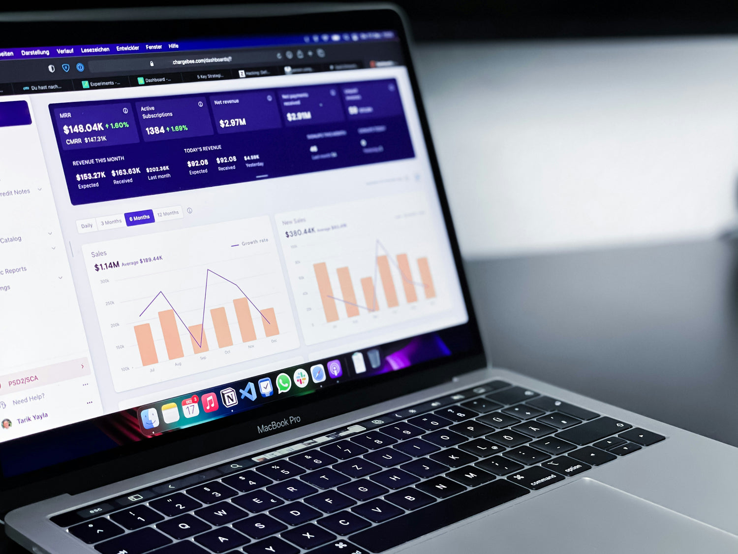 Laptop displaying financial software with charts and graphs on a blurred background. AI-powered analytics dashboard visualizing EV fleet performance, trends, and operational insights.
